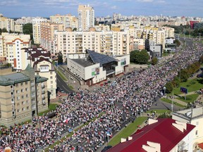 Opposition supporters parade through the streets during a rally to protest against the Belarus presidential election results in Minsk on September 13, 2020.