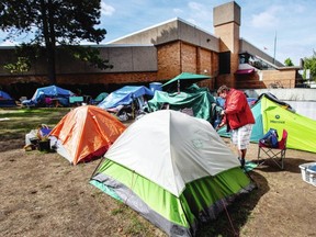 Jamie Perry cleans up in camp at Central Park near the Crystal Pool and Fitness Centre in Victoria, B.C. August 31, 2020.