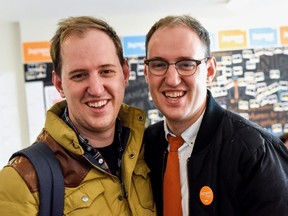 James Smith (left) works on the NDP campaign bus while his twin George Smith (right) works for NDP campaign headquarters. The party's COVID election rules mean the brothers must stay in separate bubbles throughout the campaign.