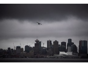 In this file photo, a seaplane takes off from the harbour under low cloud above the downtown skyline.