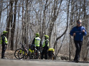 Police monitor foot traffic on Mount Royal to ensure people keep a distance from each other on April 4, 2020.