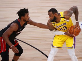 Jimmy Butler of the Miami Heat and LeBron James of the Los Angeles Lakers, right, have been battling in the 2020 NBA Finals at AdventHealth Arena at the ESPN Wide World Of Sports Complex in Lake Buena Vista, Fla.