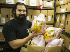 Raul Granucci, general manager of Windsor Meats on Fraser Street in Vancouver, holds a five-kilogram turkey in the service area of the shop.