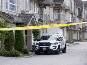 An RCMP cruiser parked outside a Surrey residence on Oct. 21, 2020.