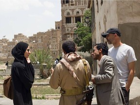 Crisis Group's CEO Rob Malley and former deputy Mena April Alley speak with a Huthi official and family member in the streets of Sanaa, Yemen.