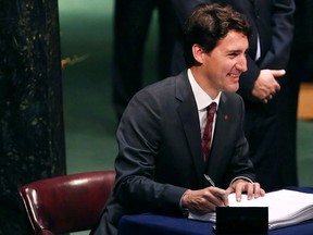 Prime Minister Justin Trudeau signs the accord at the United Nations signing ceremony for the Paris Agreement climate change accord.