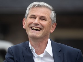 B.C. Liberal Leader Andrew Wilkinson laughs during a conversation with a reporter during a campaign stop in Maple Ridge on Tuesday.