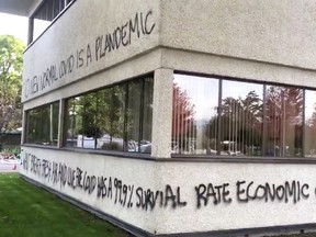 Someone armed with a spray paint can wrote COVID-19 hoax messages all across the north and west walls of Kelowna city hall.