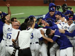 Players on the Los Angeles Dodgers celebrate Tuesday night after winning the World Series against the Tampa Bay Rays at Globe Life Field in Arlington, Texas.