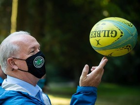 B.C. NDP Leader John Horgan spins a rugby ball on his fingers Friday during an election campaign stop at Stanley Park in Vancouver.