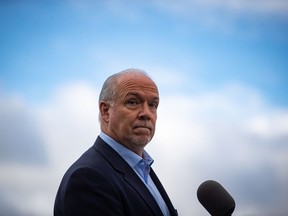 CP-Web. NDP Leader John Horgan pauses while responding to questions during a campaign stop, in Vancouver, on Monday, October 12, 2020. A provincial election will be held in British Columbia on October 24.