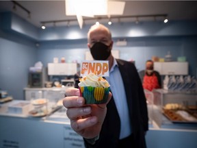 John Horgan holds an NDP-branded cupcake during a campaign stop in Pitt Meadows last week.