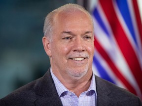 B.C. Premier-elect John Horgan smiles during a post-election news conference, in Vancouver, on Sunday.
