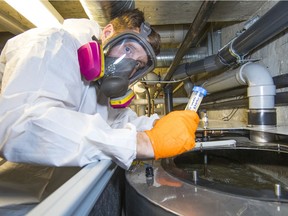 Matthew Wardlow, controls system and service specialist at SHARC Energy Systems, tests the liquid in a heat-exchanger.