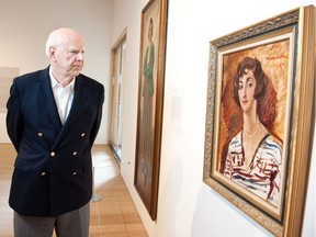 Michael Audain poses with a 1927 portrait of his mother, Madeline Stulik by the English painter Augustus John, in this 2016 photo. Audain is the chair of the Audain Foundation, which is this year awarding its prize to 12 artist-run centres instead of a single prominent artist.