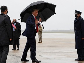 U.S. President Donald Trump walks without a mask as he boards Air Force One from Washington to Florida, his first campaign trip since being treated for the coronavirus disease (COVID-19), at Joint Base Andrews, Maryland, U.S., October 12, 2020.