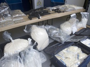 Richmond RCMP display drugs and weapons on Nov. 18 after a series of busts in the city on Oct. 28 that resulted in the seizure of all this and other drug paraphernalia, including cars, pill presses and weapon silencers.