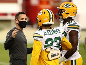 Head coach Matt LaFleur of the Green Bay Packers talks with Jaire Alexander and Oren Burks before his NFL squad defeated the San Francisco 49ers 34-17 at Levi's Stadium on Thursday in Santa Clara, Calif. Both teams had players sit out due to COVID-19.