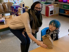 Jessica Nordal hands out lunches at Park Avenue Elementary In Nanaimo. The school has requested help from The Vancouver Sun’s Adopt-A-School (AAS) campaign so breakfast and lunch can be provided to hungry children for the rest of the school year.
