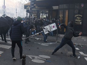 Demonstrators clashes with police during a protest against the 'global security' draft law, which Article 24 would criminalize the publication of images of on-duty police officers with the intent of harming their 'physical or psychological integrity', in Paris on Nov. 28, 2020.