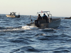 Ahousaht First Nation boats patrol an area on Monday, Oct.26, 2015 where the whale-watching boat Leviathan II capsized near Tofino, B.C. Sunday afternoon. B.C. First Nations are benefiting from a partnership through the Canada Oceans Protection Plan to improve marine safety and protect the coastal environment.