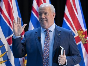 The Honourable Janet Austin, Lieutenant Governor of B.C., not seen, swears in Premier John Horgan, shown here flashing the Vulcan salute, meaning "live long and prosper," during a virtual swearing in ceremony in Victoria, Thursday, Nov. 26, 2020. THE CANADIAN PRESS/Jonathan Hayward