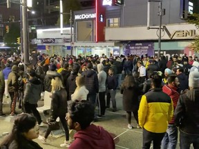 Halloween partiers are seen filling Granville Street in downtown Vancouver on Halloween, Oct. 31, 2020. Vancouver Police are planning extra enforcement in the Granville Entertainment District on New Year's Eve.