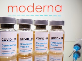 Vials with a sticker reading, "COVID-19 / Coronavirus vaccine / Injection only" are seen in front of a Moderna logo in this illustration taken October 31, 2020.