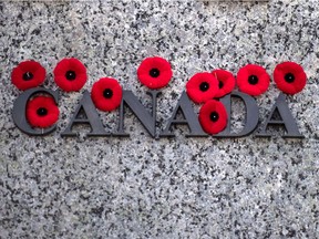 Poppies are seen on the National War Memorial after Remembrance Day ceremonies in Ottawa in 2018.