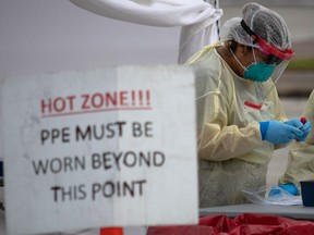 A health-care worker prepares specimen collection tubes at a coronavirus disease (COVID-19) drive-thru testing location in Houston, Texas on Nov. 20, 2020.