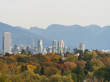 The Vancouver skyline rises above a colour tree canopy in Vancouver, B.C. Oct. 25, 2020.