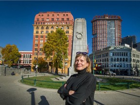 Eve Lazarus is seen here at Victory Square with Dominion Building at Hastings and Cambie streets behind her. Lazarus's new book is titled Vancouver Exposed and includes interesting stories about both these landmarks