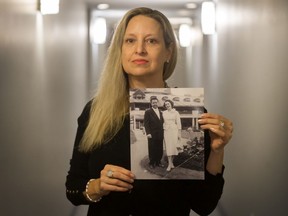 Cath-Anne Ambrose with an old photo of her mom (with husband William), who is in a care home.