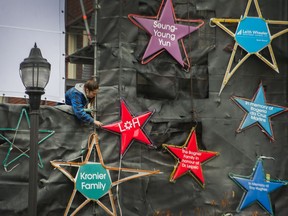 A damaged extension cord sparked a small fire Saturday evening at St. Paul's Hospital's Lights of Hope display. In this photo, a worker can be seen fixing stars on the Lights of Hope display on Sunday, Nov. 22, 2020 in Vancouver, B.C.