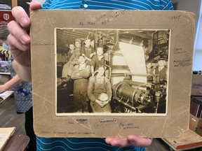 Brian Gibson of Unifor holds a 1914 photo of pressmen at the Vancouver Daily Province.