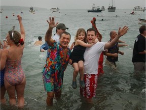 Here the Pantages family in 2003, led by Basil Pantages, in bright aloha shirt, take a dip and revel in the freezing waters of English Bay as they welcome in the new year in style.