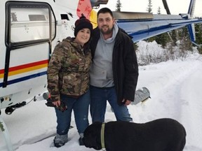 Tamara Sandulak and Cody Martin with dog Rex shortly after they were found at Moriarty Lake on Saturday. They had been reported missing on Wednesday.