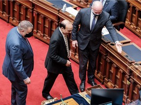 Raj Chouhan, MLA for Burnaby-Edmonds, is escorted to his throne by Premier John Horgan (right) as the new Speaker of the legislature on Monday.