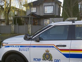 An RCMP cruiser sits in front of a home on Oxford Street in Burnaby on Tuesday.