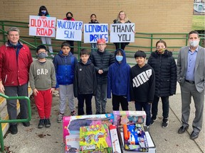 Joe Leibovitch, far right, with students and staff of Old Yale Road Elementary give a COVID-19 long-range thank you to London Drugs staff bringing them presents.