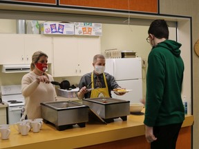 Principal Peter Gajda and teacher Jamie Sing serving hot breakfast this week at Nakusp Secondary School.