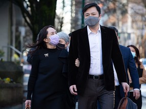 Meng Wanzhou, chief financial officer of Huawei, returns to B.C. Supreme Court with her husband Liu Xiaozong, after a break from a hearing in Vancouver on Wednesday, Dec. 9, 2020.