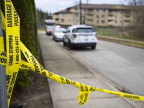 Homicide investigators on the scene in Surrey on Dec. 3, 2020 of a fatal shooting earlier that day, in which a woman died in her vehicle in the alleyway of the 13700-block of 75A Avenue.
