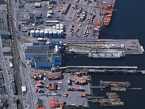 A file aerial photo of West Coast Reduction’s plant (round white tanks) on the south side of Vancouver Harbour.