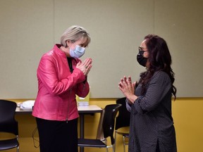 Nisha Yunus, a residential care aide at Providence Health Care and Dr. Bonnie Henry, Provincial Health Officer react after Yunus was injected with a dose of the Pfizer-BioNTEch COVID-19 vaccine by Christina Cordova, a regional immunization clinical resource nurse in Vancouver, British Columbia, Canada December 15, 2020.