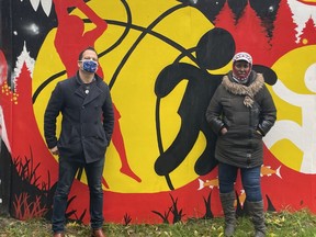 Jonathon Ross of the Wrap program and Jaqueline Soleil stand in front of a Surrey mural painted by students being help by program, one of whom was Soleil's daughter Miriam.