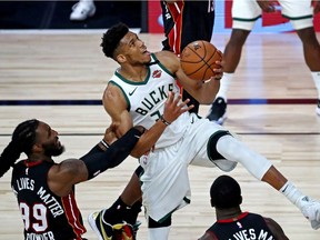 Milwaukee Bucks forward Giannis Antetokounmpo (34) drives to the basket against Miami Heat forward Jae Crowder (99) during the third quarter in game three of the second round of the 2020 NBA Playoffs at ESPN Wide World of Sports Complex