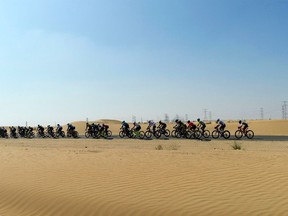 Cyclists compete in the local Al-Silm cycling race in the desert outside the Gulf emirate of Dubai on December 7, 2020.