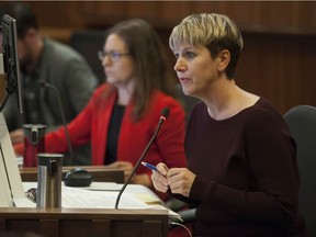 Vancouver city councillors Lisa Dominato, left, and Sarah Kirby-Yung are pictured in a 2019 council meeting at city hall.