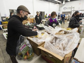 Volunteers prepare food hampers at the Broadway Church in Vancouver on Dec. 17, 2020. Broadway Church has given away more than $2 million in donated food to the needy since the COVID-19 pandemic began.